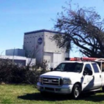 Tree Man Inc. truck and chipper trailer beside a storm damaged tree during tree removal in Kenner, LA